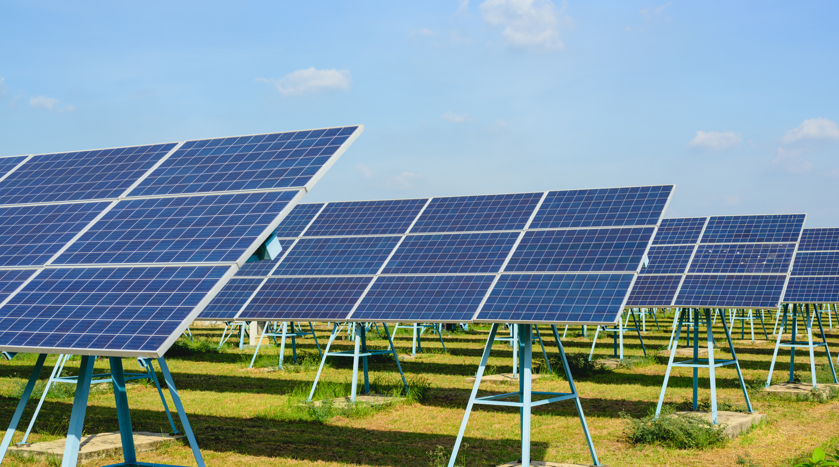 Photovoltaic solar panels with sun at solar cell farm field